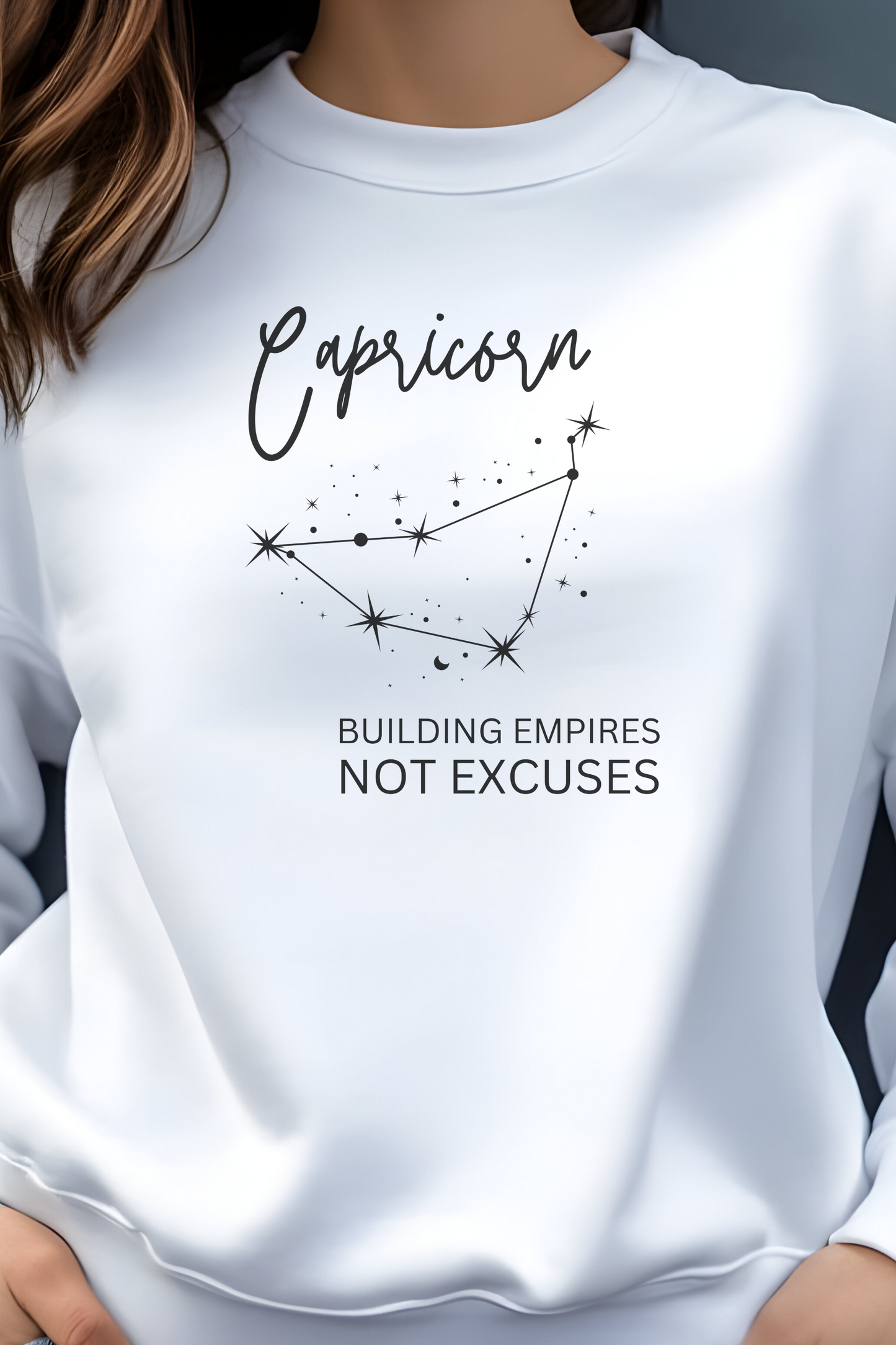 White sweatshirt with Capricorn zodiac design and text on a plain background