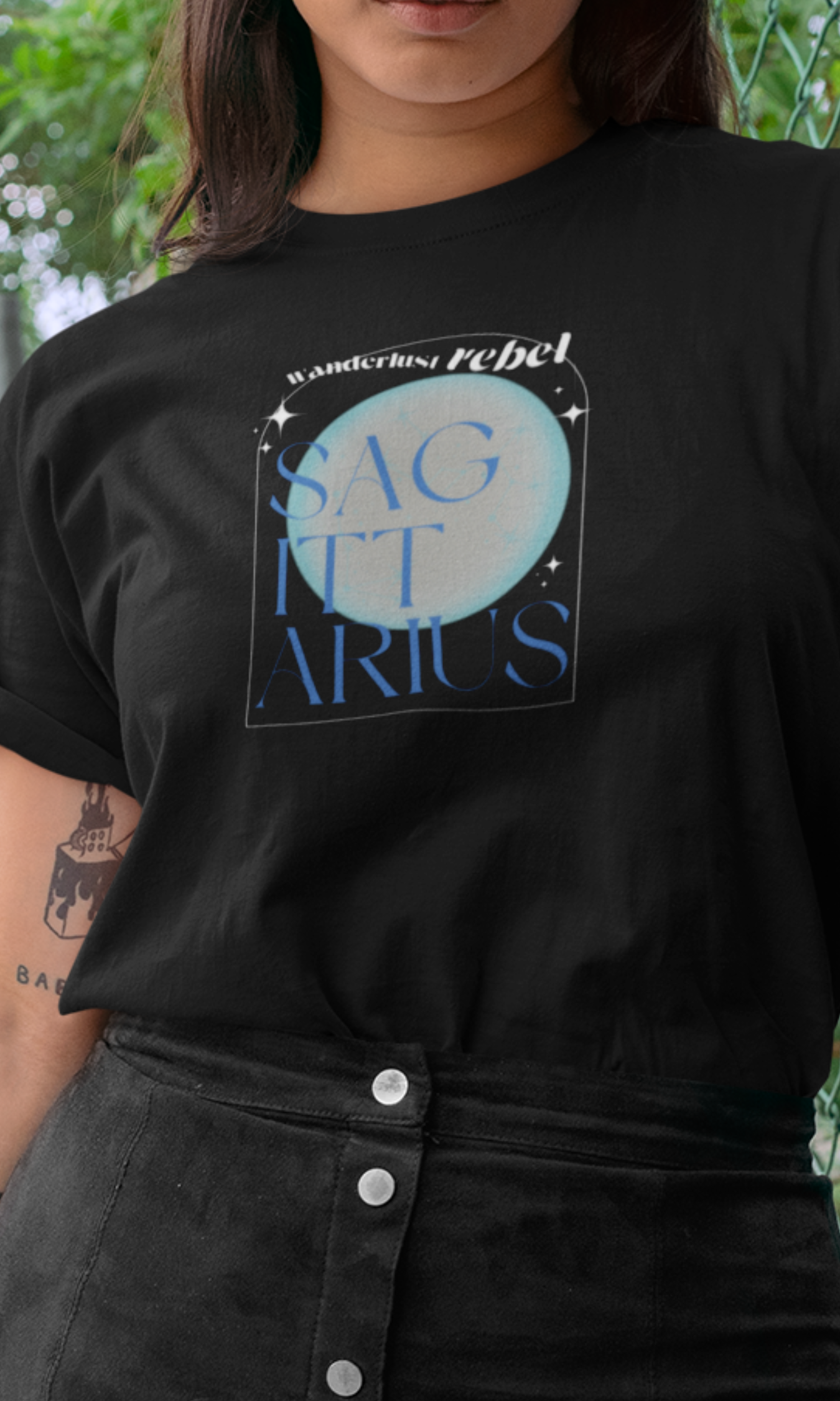 Person wearing a black t-shirt with 'Sagittarius' design and text.