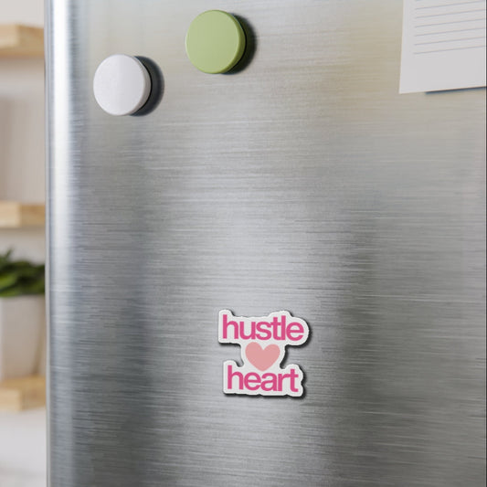 Magnet with 'hustle heart' text on a metallic surface