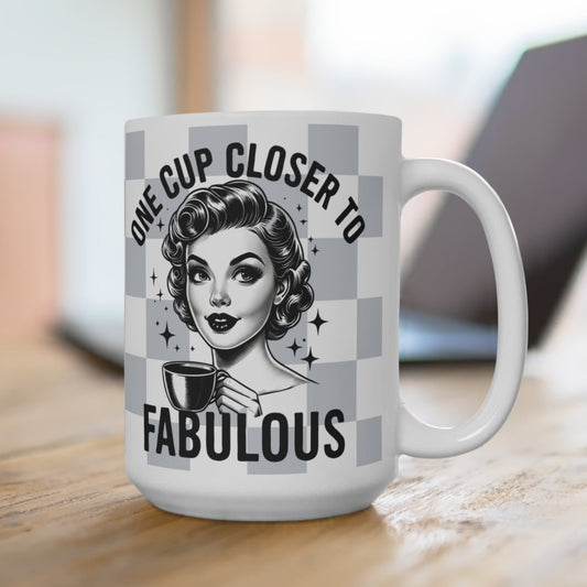 Mug with a design of a woman holding a coffee cup and text 'One cup closer to fabulous' on a blurred background.