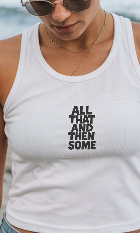 Person wearing a white tank top with text 'All That And Then Some' against a blurred natural background.