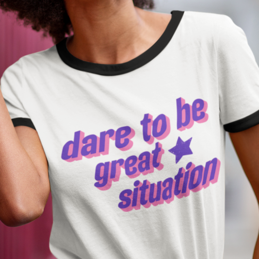 Person wearing a white t-shirt with colorful text design.