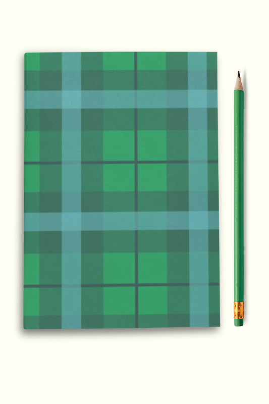 Notebook with green plaid pattern and a pencil on a white background