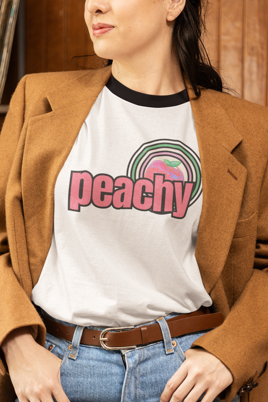 Person wearing a 'peachy' t-shirt with a brown blazer and blue jeans in a record store.