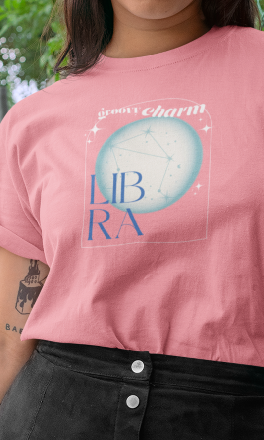 Person wearing a pink t-shirt with 'Gummy Charm Libra' design