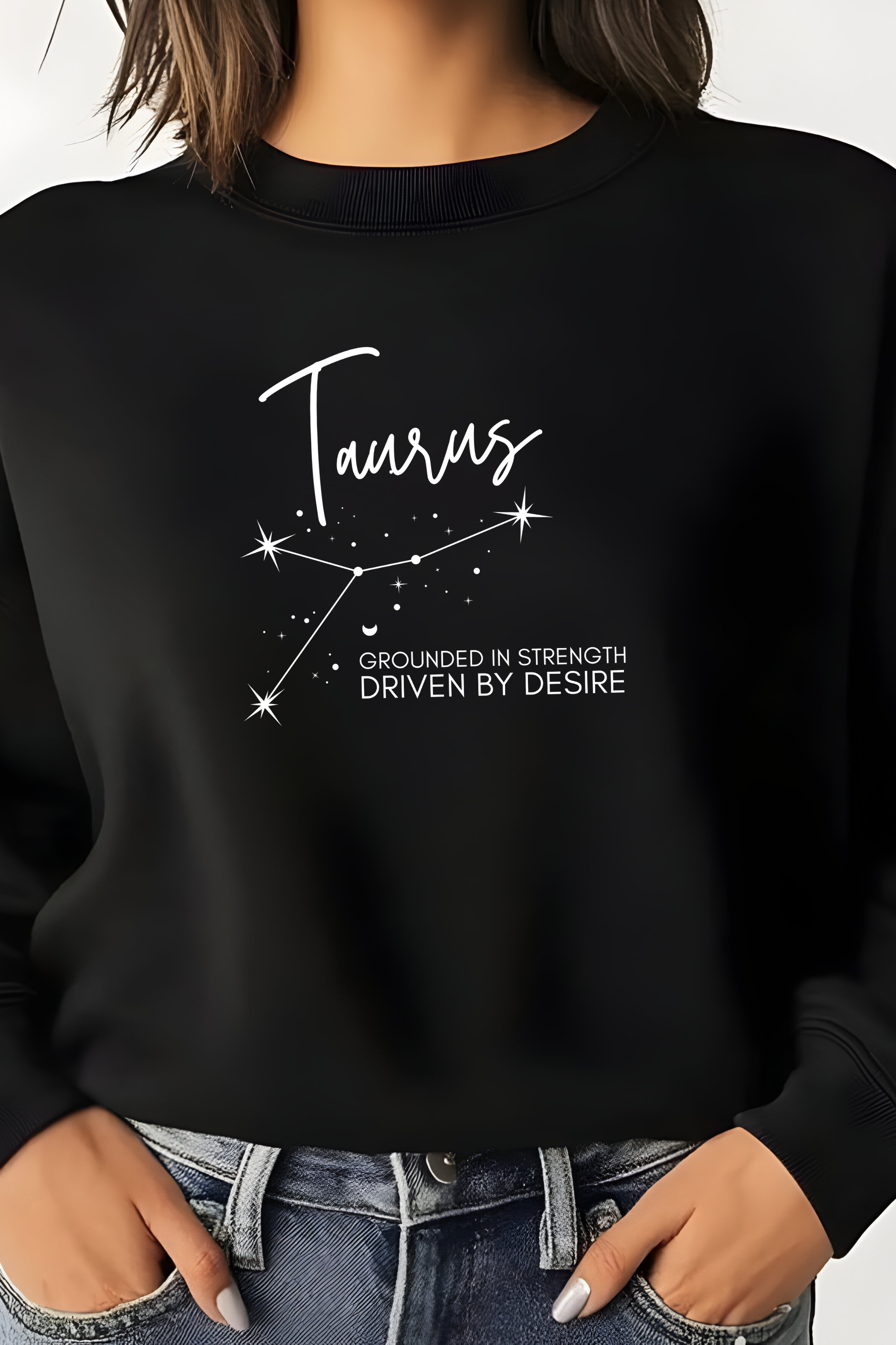 Black sweatshirt with Taurus zodiac design and text on a plain background